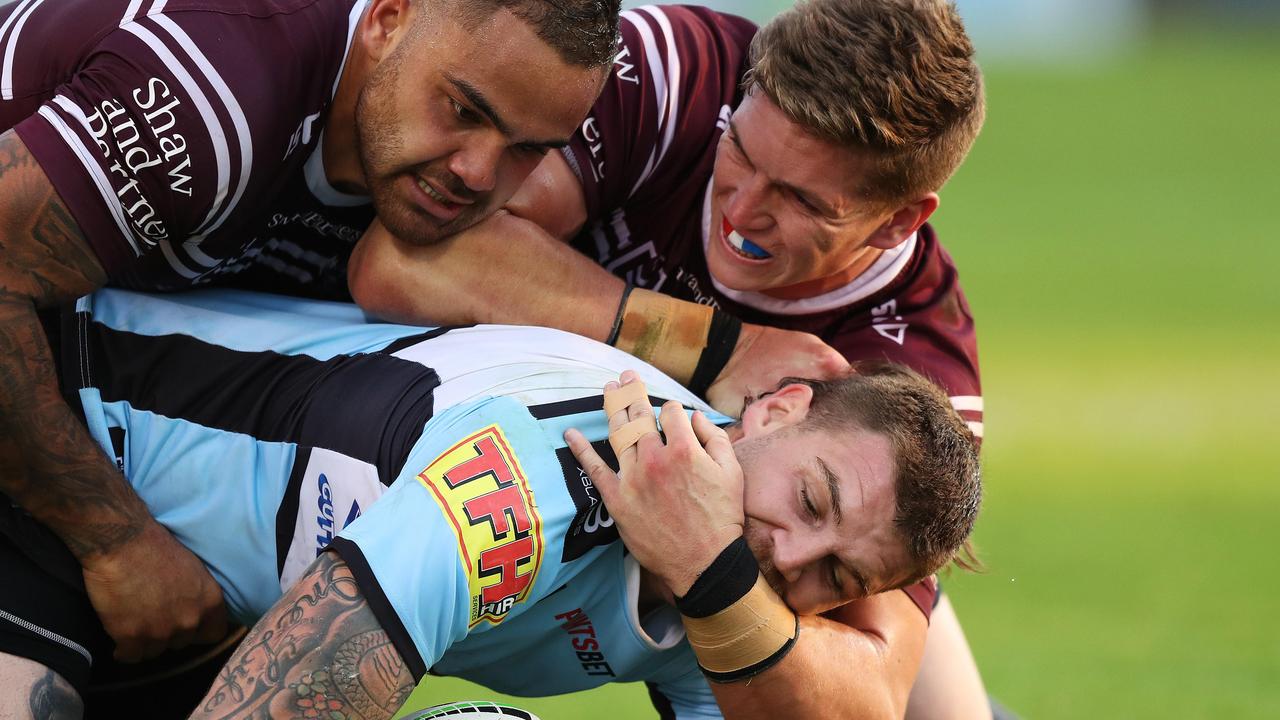 Cronulla's Josh Dugan is tackled by the Manly defence