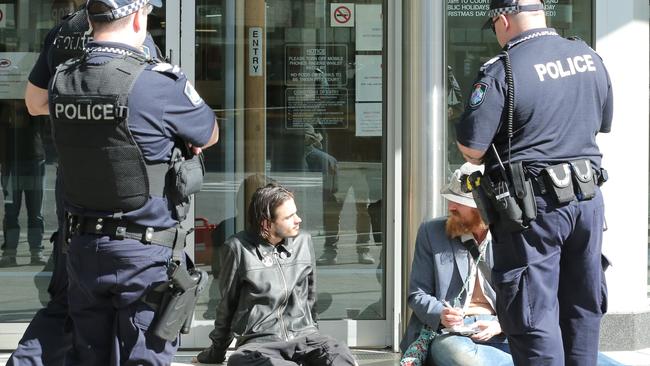 Protesters questioned by police for trying to block the entrance way.