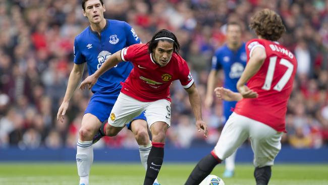 Manchester United's Radamel Falcao Garcia, center left, passes the ball to teammate Daley Blind.