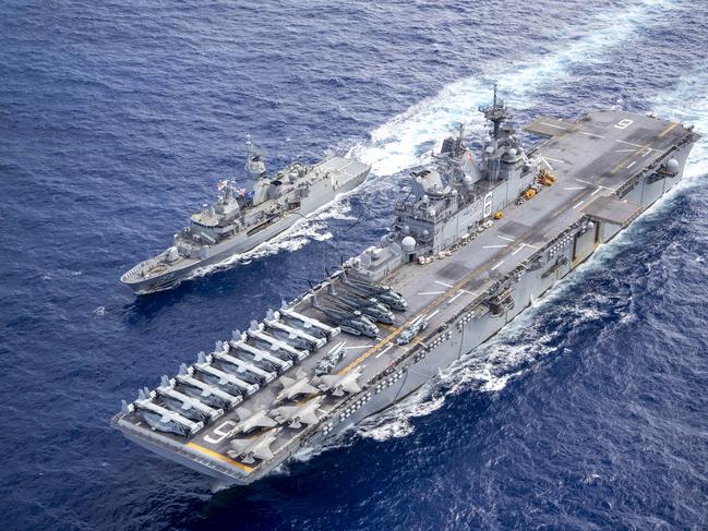 Royal Australian Navy ship HMAS Ballarat (left) and USS America conduct a replenishment at sea off the coat of Queensland, during Exercise Talisman Sabre 2021. Picture: Supplied