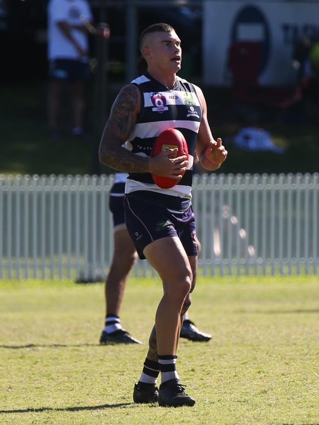 Pictured: Crocs defender Harvey Moore and Tiger Ben Deluca. Port Douglas Crocs v North Cairns Tigers at Port Douglas Sporting Complex. Round 9 AFL Cairns 2024. Photo: Gyan-Reece Rocha