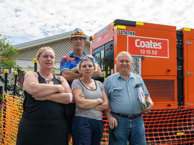 Kerri Mason, Kerrie Dowd, Pat Wilcocks and George Pawlowski with one of the eight generators that have been supplying power to the flood damaged community. Picture Emily Barker.