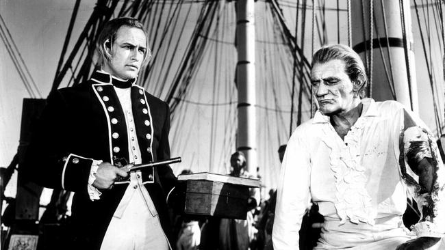 Marlon Brando, as Fletcher Christian, with Trevor Howard, as Captain William Bligh, in Mutiny on the Bounty.