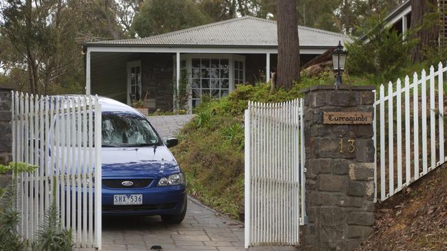 A police car leaves the home of Marea Yann in Juliet Crescent, Healesville.