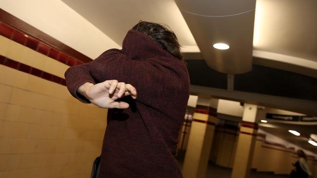 Mitchell Thornton hides his face after his court appearance. Picture: Toby Zerna