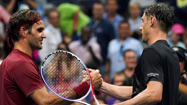 John Millman (right) shakes hands with Roger Federer after his fourth round win on Tuesday