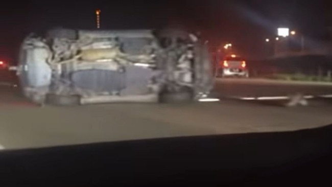 A Rav 4 on its side in the middle of the motorway following the accident. Picture: Facebook