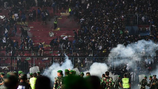 Security personnel deployed tear gas into Kanjuruhan stadium from the pitch in Malang, East Java. Picture: AFP