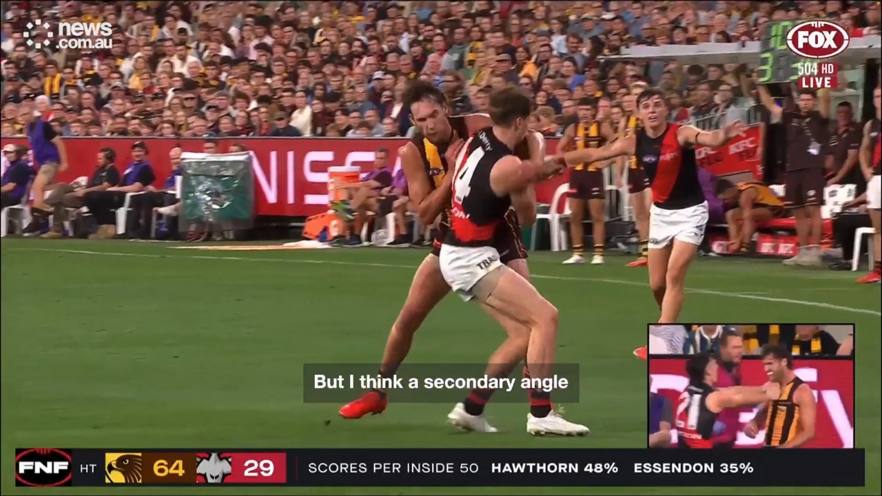 Jack Scrimshaw cleans up Essendon's Jordan Ridley with a swinging arm