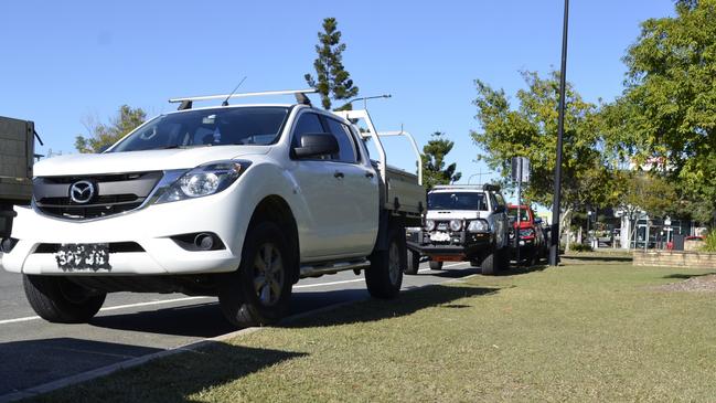 Vehicles "polite parked" near a construction site on Lakefield Drive, North Lakes to avoid crossing the marked line. Picture: David Alexander