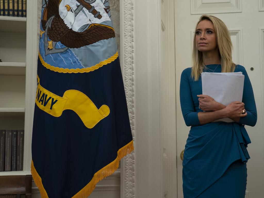 White House press secretary Kayleigh McEnany listens as President Donald Trump speaks before signing a coronavirus aid package to direct funds to small businesses, hospitals, and testing, in the Oval Office last month. Picture: AP Photo/Evan Vucci