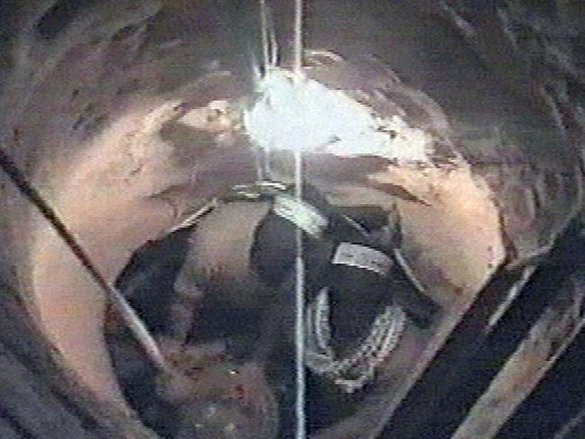 DECEMBER 12, 2004 : TV grab taken from  video by the militant Palestinian group Hamas, shows masked militants gathering objects that were lowered down to them in a tunnel near the Gaza-Egypt crossing 12/12/04, used in underground attack on an Israeli army base that killed 4 soldiers.Israel / Terrorist / Terrorism