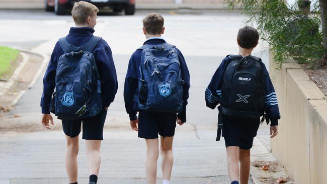 Students on their way to school in South Australia, which hasn’t locked down to the level of other states. Picture: AAP