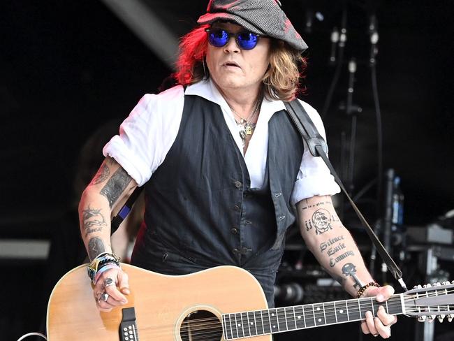 TOPSHOT - Johnny Depp performs on stage with Jeff Beck during the Helsinki Blues Festival in Helsinki on June, 19, 2022. (Photo by Jussi Nukari / Lehtikuva / AFP) / Finland OUT