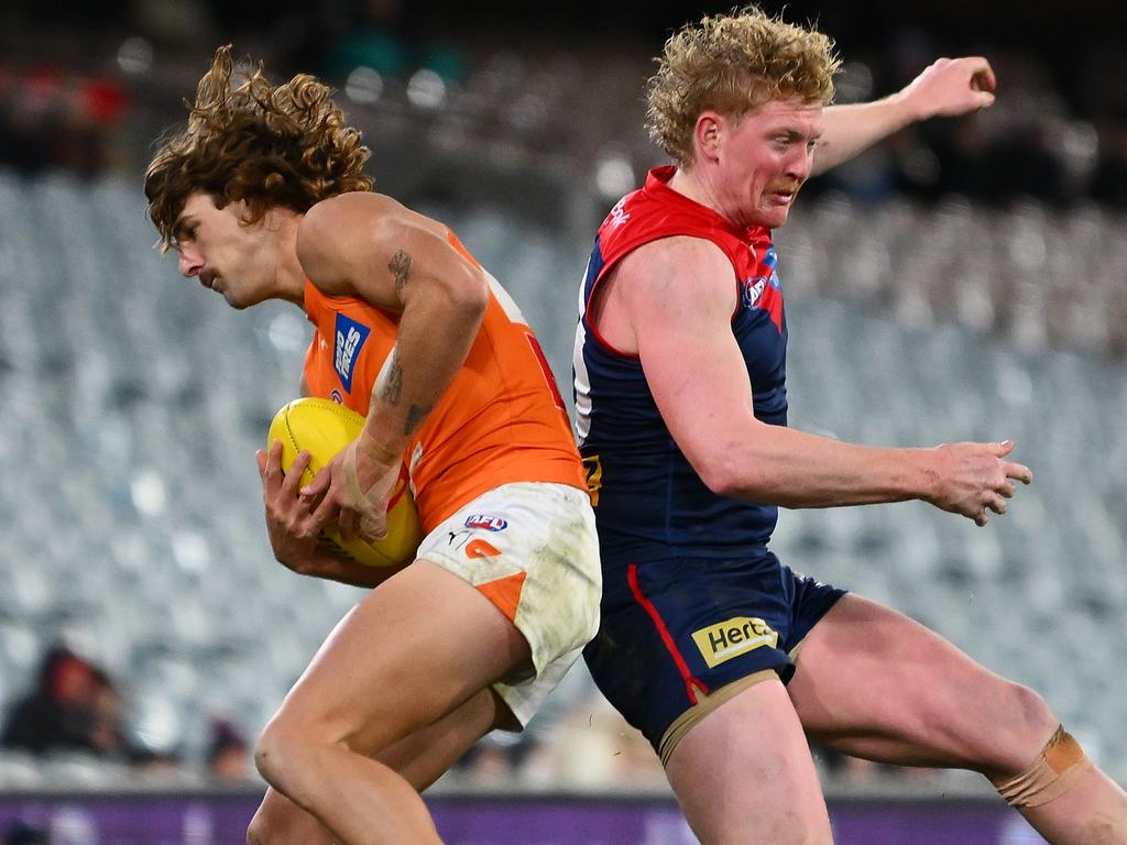 James Peatling and Clayton Oliver vie for possession. Picture: Morgan Hancock/AFL Photos/via Getty Images