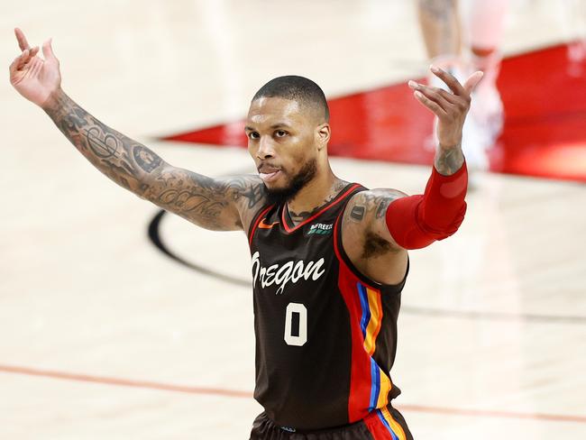 PORTLAND, OREGON - JUNE 03: Damian Lillard #0 of the Portland Trail Blazers reacts after his three point basket in the second quarter against the Denver Nuggets during Round 1, Game 6 of the 2021 NBA Playoffs at Moda Center on June 03, 2021 in Portland, Oregon. NOTE TO USER: User expressly acknowledges and agrees that, by downloading and or using this photograph, User is consenting to the terms and conditions of the Getty Images License Agreement.   Steph Chambers/Getty Images/AFP == FOR NEWSPAPERS, INTERNET, TELCOS & TELEVISION USE ONLY ==