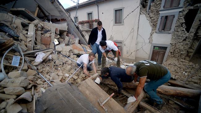 Residents search for victims in the rubble after a strong earthquake hit Amatrice in Central Italy. Picture: Filippo Monteforte.