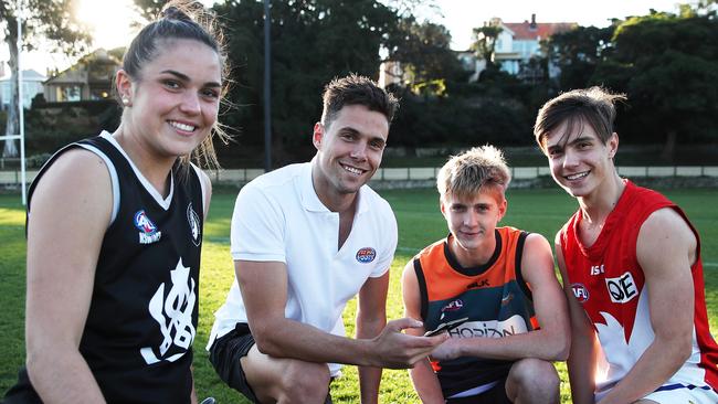 Kelly meets junior footballers Laura Marshall, Joel Ditcham and Jack Hauschild at Birchgrove Oval to promote the Fit For Footy App. Picture: Phil Hillyard