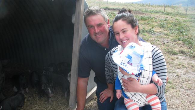 Pig producers Damien and Lillian Reardon, with baby Gideon, of Huon Valley Berkshires and boar Mr Rochester. Picture: ELAINE REEVES