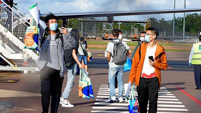 Foreign students disembarking from an international flight at Darwin Airport this week. Picture: Charles Darwin University