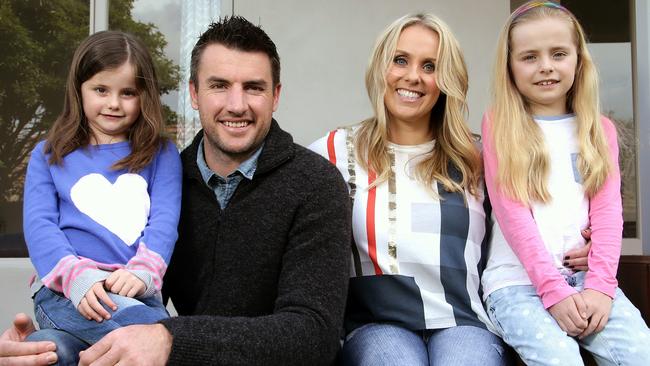 Former AFL footballer Darren Jolly with wife Dee and daughters Scarlett and Lily. Picture: Hamish Blair