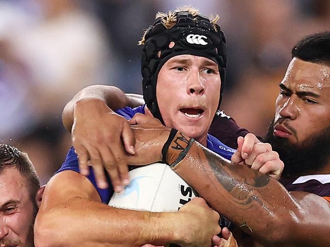 SYDNEY, AUSTRALIA - MARCH 20:  Matt Burton of the Bulldogs is tackled during the round two NRL match between the Canterbury Bulldogs and the Brisbane Broncos at Accor Stadium, on March 20, 2022, in Sydney, Australia. (Photo by Mark Kolbe/Getty Images)