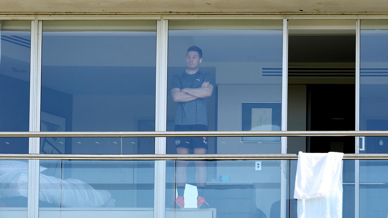 Toby Greene watches the Swans train from his room today. Picture: Michael Klein