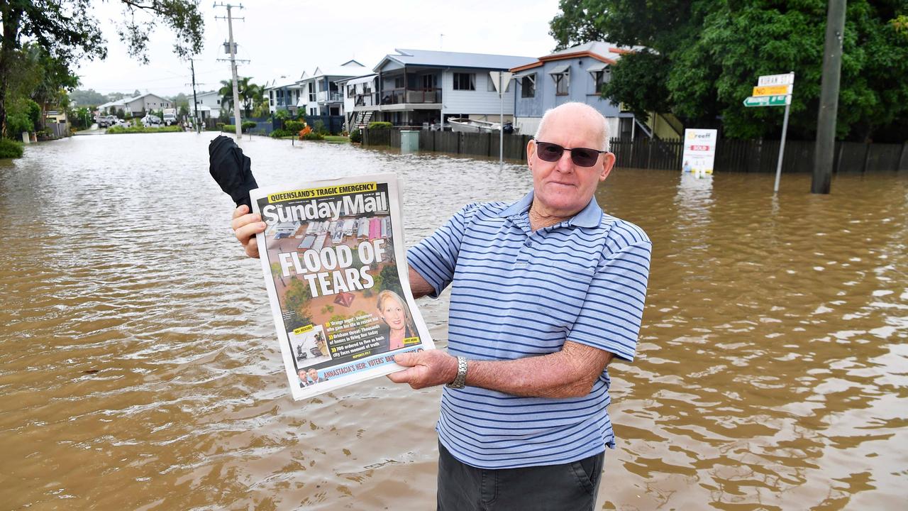 Bradman Ave remains closed as residents prepare for more rain and heavy flooding to hit the Sunshine Coast. Ray Thompson with his copy of the Courier Mail. Picture: Patrick Woods.