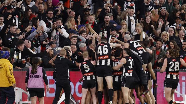 Collingwood players and fans go wild after another close win. Picture: Darrian Traynor/Getty Images