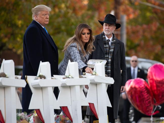 US President Donald Trump and First Lady Melania Trump, alongside Rabbi Jeffrey Myers, place stones and flowers on a memorial as they pay their respects at the Tree of Life Synagogue following the October 2018 shooting in Pittsburgh, Pennsylvania. Picture: AFP