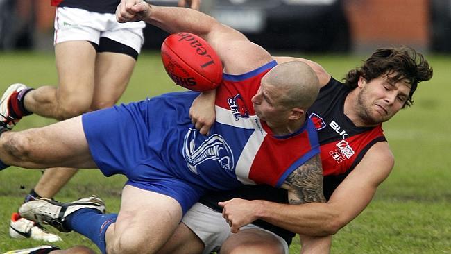 Sandown veteran Matt Menzies battles it out with Black Rock’s Joe Krieger. Picture: Richa