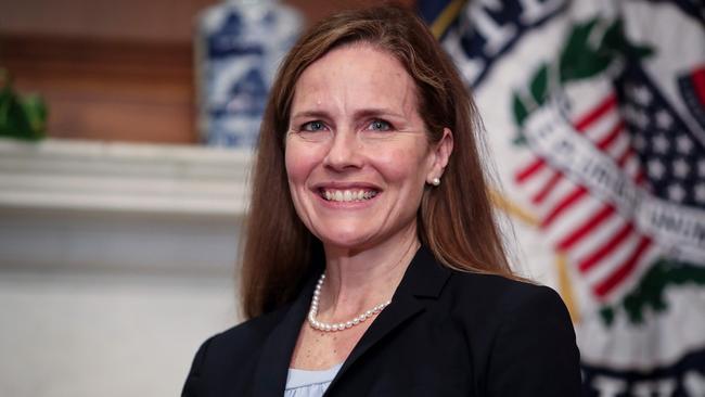 Judge Amy Coney Barrett smiles as she meets a senator at the end of her courtesy call at the US Capitol in Washington, DC. Picture: AFP