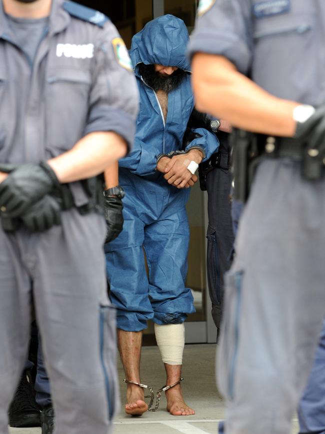 Naden in chains and bandages after being bitten by a police dog during his arrest. File picture