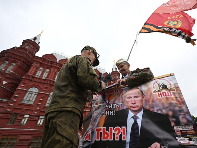 Activists hold a portrait of Russian President Vladimir Putin near Red Square in Moscow, on June 24. Picture: AFP