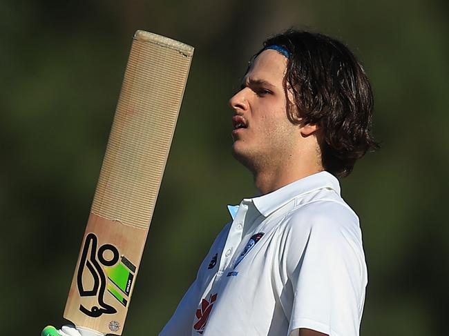 SYDNEY, AUSTRALIA - OCTOBER 10: Sam Konstas of the Blues raises his bat in the air after hitting a six to reach his century during the Sheffield Shield match between New South Wales and South Australia at Cricket Central, on October 10, 2024, in Sydney, Australia. (Photo by Mark Evans/Getty Images)