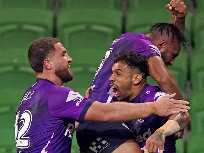 Josh Addo-Carr of the Storm celebrates after scoring a try with Justin Olam of the Storm and Kenny Bromwich of the Storm during the Round 4 NRL match between Melbourne Storm and the South Sydney Rabbitohs at AAMI Park in Melbourne, Friday, June 5, 2020. (AAP Image/Scott Barbour) NO ARCHIVING, EDITORIAL USE ONLY