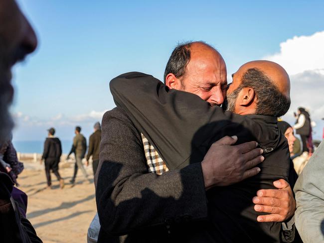 A man embraces another after having crossed the Netzarim corridor from the southern Gaza Strip north into Gaza City along Gaza's coastal al-Rashid Street. Picture: AFP