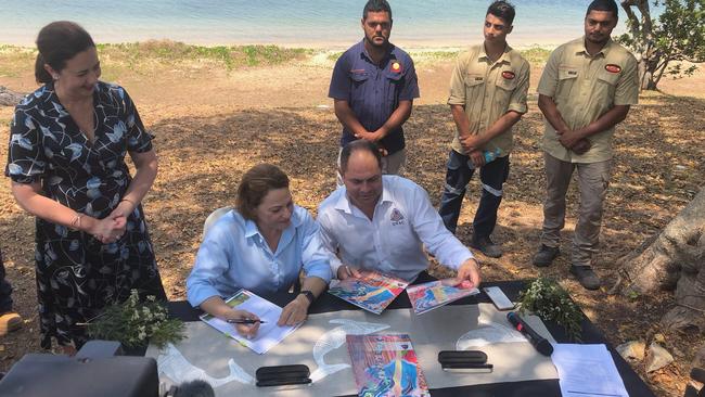 Premier Annastacia Palaszczuk watches as Jackie trad and Cameron Costello look over maps for the island last year.