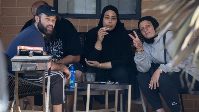 Associates of Sarah Abu Lebdeh outside her Condell Park home on Wednesday afternoon.