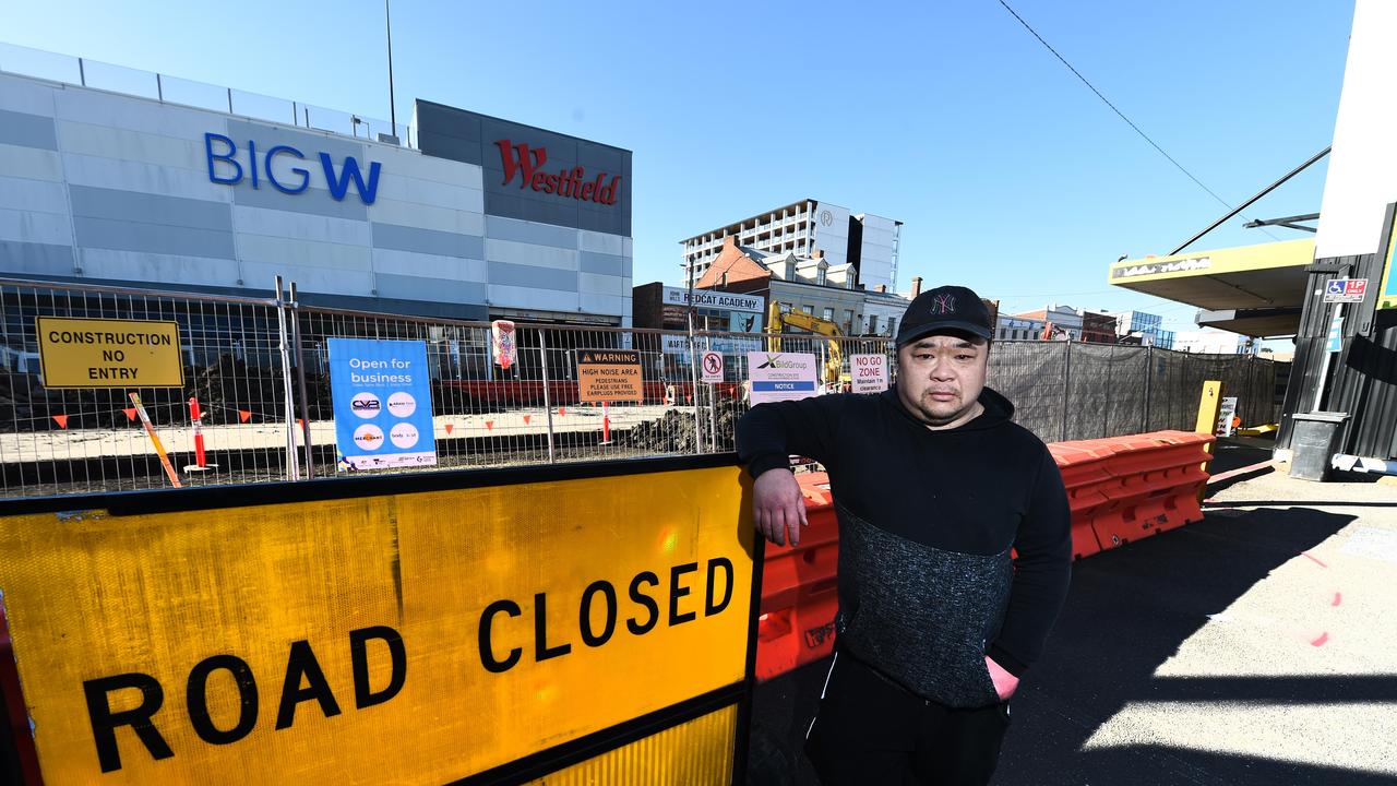 Andrew Le who owns the Asian grocer looking mad with the construction in the background. He said business is down 50% because of the construction.