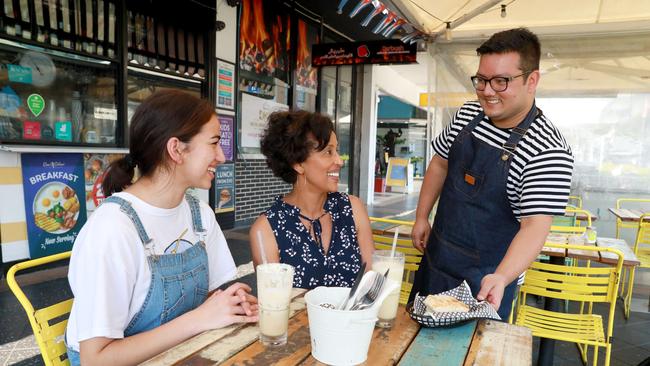 Waiter Roshan Simkhad serves Rowena Milliss and her mum Saba Tedla at Coco Cubano. Picture: Angelo Velardo