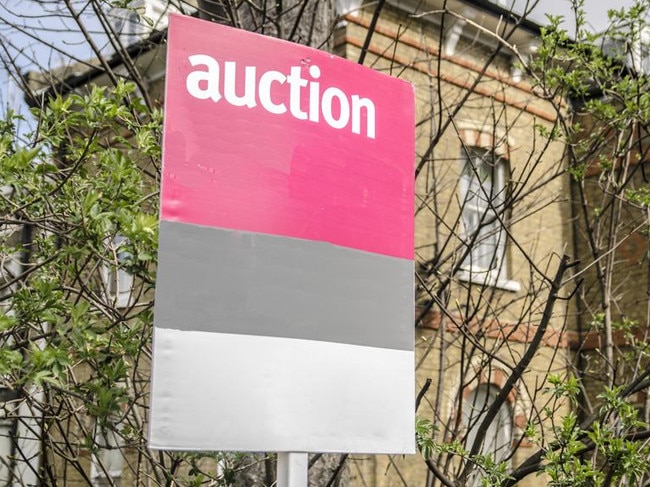 Auction sign with building background