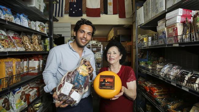 David Corrochano and Kata Pennisi at Pennisi Cuisine, with some salami batons and wheels of cheese. Photo Mark Cranitch.