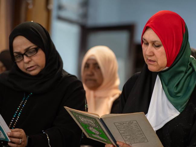 A Muslim woman wears a Palestinian flag as she joins worshippers reciting verses of the Koran during a Solidarity with Palestine event, at the al Quds Mosque in Cape Town. Picture: AFP