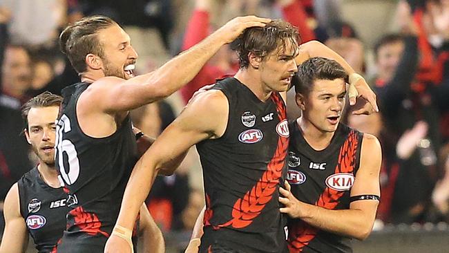 Joe Daniher is mobbed by teammates after kicking a goal. Picture: AAP