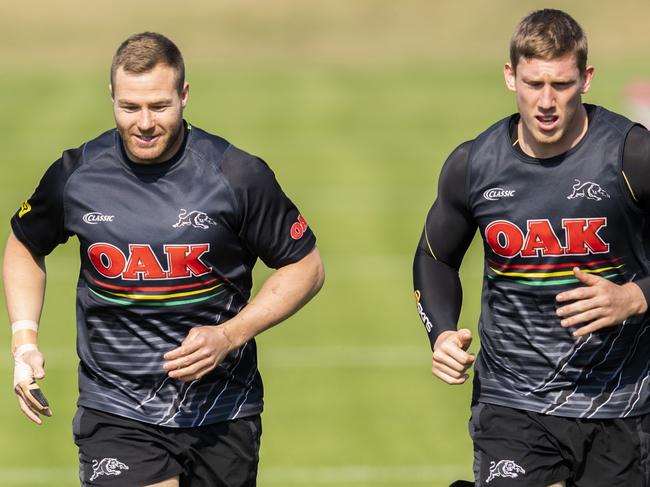 Penrith's Trent Merrin (left) training with a special guard on his finger