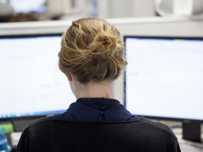 A woman sitting at a desk with a computer monitor displaying ACORN the Australian Cybercrime Online Reporting Network website. Picture: Supplied