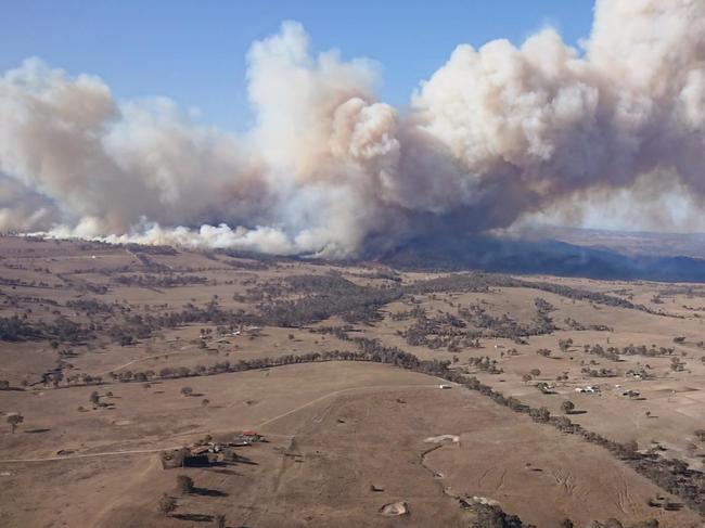 Bush fires swept through the country town of Tenterfield yesterday with several homes lost. Pictured are aerial photos of the fire taken on the first day. Picture: Supplied.