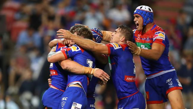 NEWCASTLE, AUSTRALIA - MARCH 15: Newcastle Knights players celebrate a try during round one NRL match between the Newcastle Knights and the Cronulla-Sutherland Sharks at McDonald Jones Stadium on March 15, 2019 in Newcastle, Australia. (Photo by Tony Feder/Getty Images)