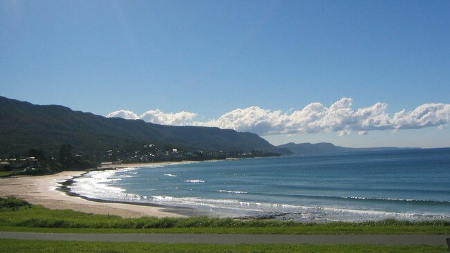 A man and child are missing after a boat capsized off Bulli Beach.